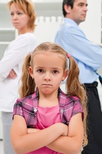 Child Standing Between Splitting Parents